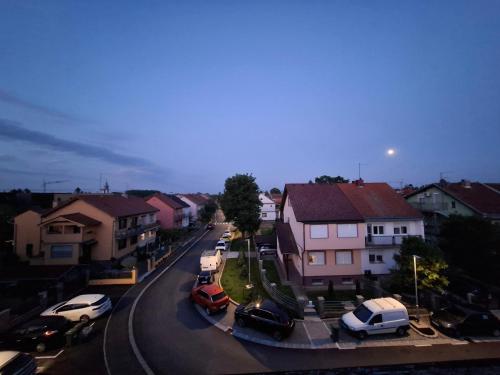 a city street with cars parked on the road at Mansarda in Osijek