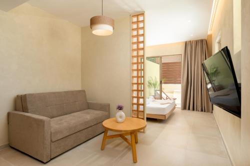 a living room with a couch and a table at Açai Plant Based Hotel in Rhodes Town