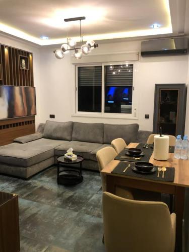 a living room with a couch and a table at Well equipped apartment with luxurious interior furnishings in Tangier