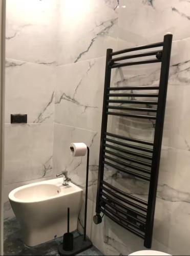 a bathroom with a white sink and a shelf at Well equipped apartment with luxurious interior furnishings in Tangier