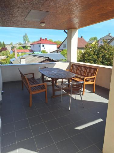 a patio with a table and chairs on a balcony at Apartmán v Plané in Tachov