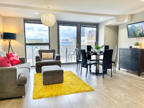 a living room with a table and a dining room at Contemporary Apartments with Private Balconies in Hoxton near Shoreditch, Old Street, Islington by Staylio Ltd in London