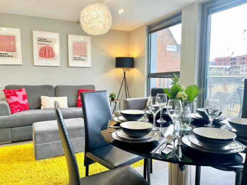 a dining room with a table and a couch at Contemporary Apartments with Private Balconies in Hoxton near Shoreditch, Old Street, Islington by Staylio Ltd in London