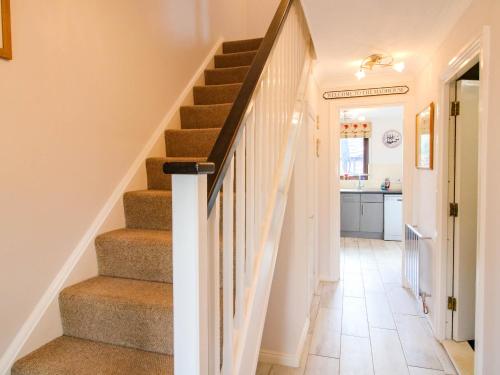 a hallway with stairs in a home with a kitchen at 63 Severn Street in Bridgnorth