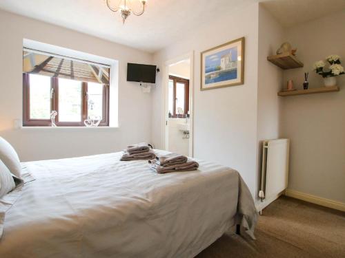 a bedroom with a bed with towels on it at 63 Severn Street in Bridgnorth