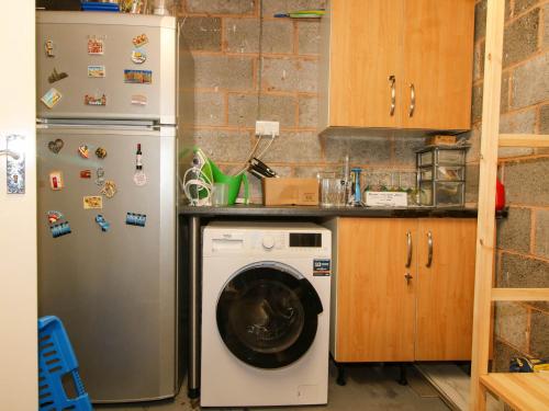 a kitchen with a refrigerator and a washing machine at 63 Severn Street in Bridgnorth