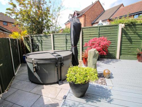 a patio with two trash cans and an umbrella at 63 Severn Street in Bridgnorth