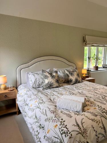 a bedroom with a bed with pillows on it at Roost in Heyshott in Midhurst