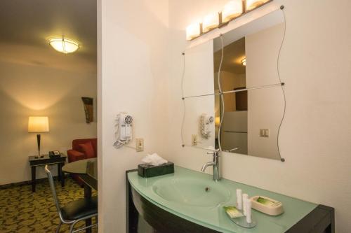a bathroom with a sink and a mirror at Hotel Extended Studio Inn in Victorville