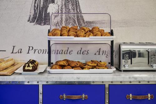 a counter with a display of bread and pastries at Nice Excelsior Centre ville by HappyCulture in Nice