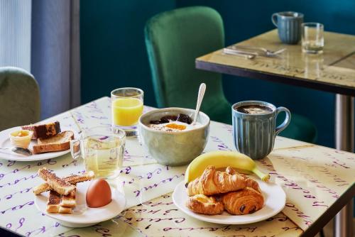 a table with two plates of breakfast foods on it at Nice Excelsior Centre ville by HappyCulture in Nice