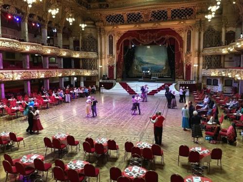 a group of people dancing in a large room at The Bungalow and Studio Apartments in Lytham St Annes