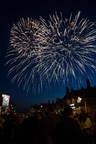 a crowd of people watching a fireworks display at night at The Bungalow and Studio Apartments in Lytham St Annes
