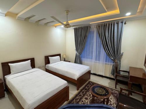 Vuode tai vuoteita majoituspaikassa Relax Inn Skardu