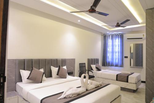 a bedroom with two beds and a couch at S K Residency in Vrindāvan