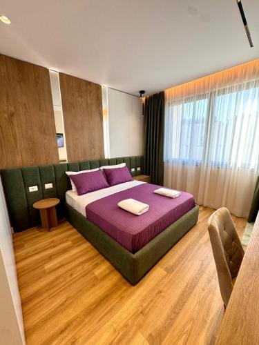 a bedroom with a bed with two towels on it at Pearl Pool Luxury Villa in Golem