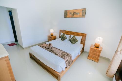Ένα ή περισσότερα κρεβάτια σε δωμάτιο στο Uluwatu Jungle Villa