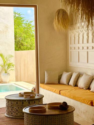 a living room with a couch and a table at Tulia House Lamu in Lamu