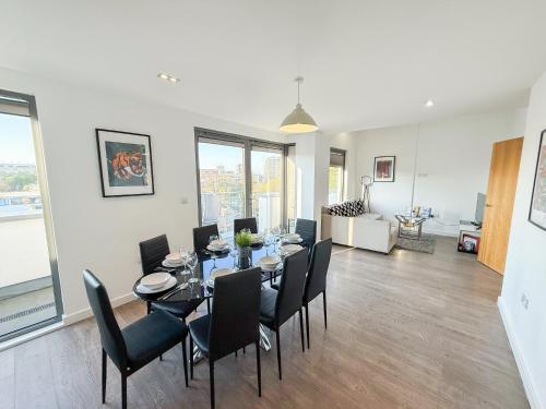 a dining room with a table and chairs at Contemporary Apartments with Private Balconies in Hoxton near Shoreditch, Old Street, Islington by Staylio Ltd in London