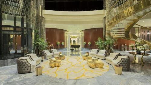a lobby with chairs and tables in a building at 4905 Luxury View By Royal Sky Vacation Homes Paramount Tower A in Dubai