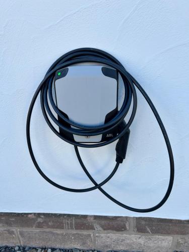 a black hose hanging on a wall at Feriendomizil im Saarschleifenland in Mettlach