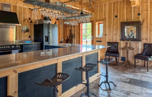 a kitchen with a large counter with stools at Gorgeous Home In Ydre With Sauna in Hult
