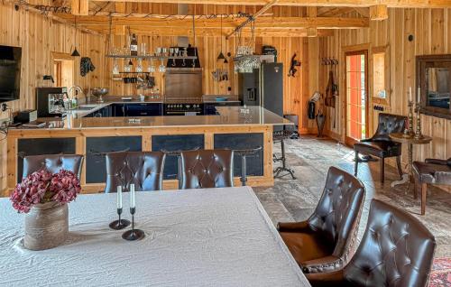 a kitchen with a table with chairs and an island at Gorgeous Home In Ydre With Sauna in Hult