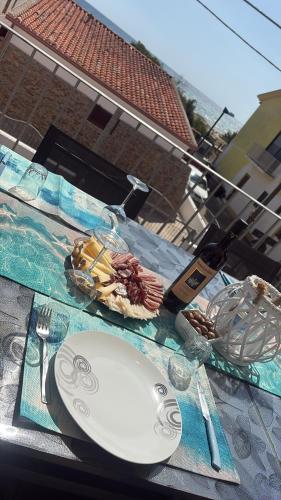 a table with a plate of food on a table at all ombra dei pini in La Caletta