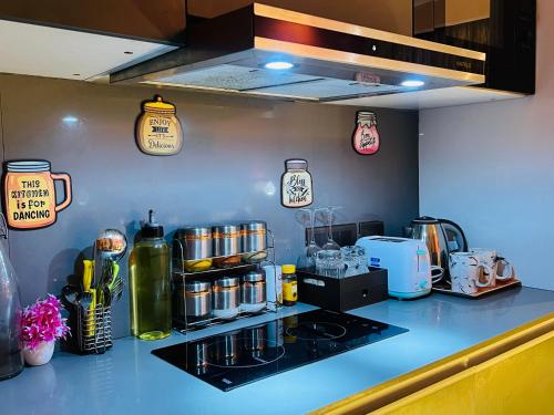 a kitchen with a counter top with a stove and appliances at Spira Supernova in New Delhi