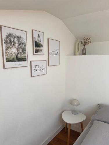 a bedroom with four pictures on the wall at Garda Suite 50 in Arco