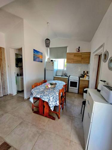 a kitchen with a table and a dining room at ANDRIA in Peristerona