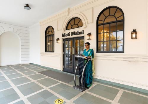 a woman standing in front of a meatmatch manual store at Saltstayz Autograph - Connaught Place in New Delhi