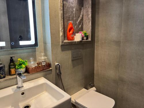 a bathroom with a sink and a toilet at Spira Supernova in New Delhi