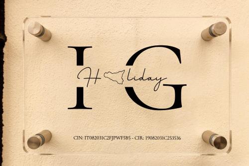 a wooden block with the periodic sign for aaturday eq at IG Holiday in Cinisi
