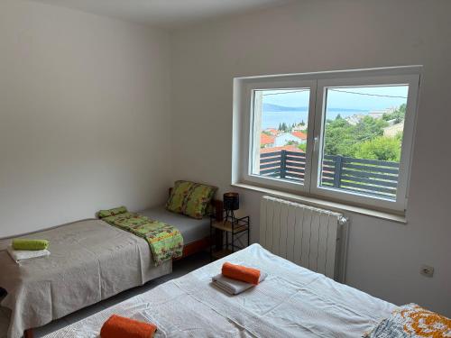a room with two beds and a window at Apartments Lili in Senj