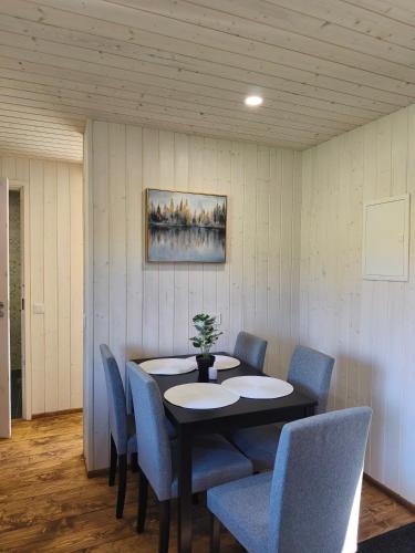 a dining room with a table and blue chairs at Family vacation, 2 bedroom house - Red House in Lõupõllu