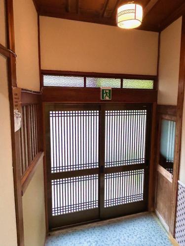 an entrance to a building with a large door at 質本宿Shichibonya戸尾町 in Sasebo