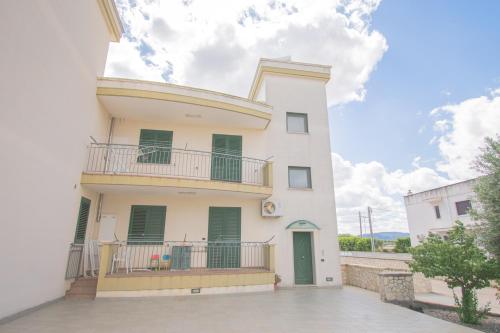 a white house with a balcony on the side of it at Casa Bellavista in Torre Canne