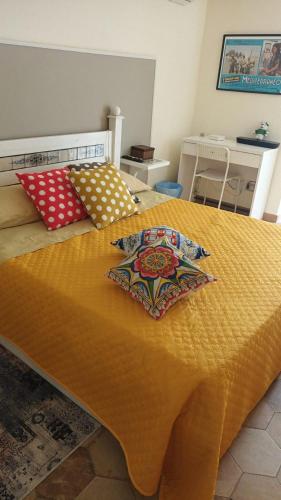 a bed with two pillows on top of it at Ragusa exclusive flat with terrace & BBQ in Ragusa