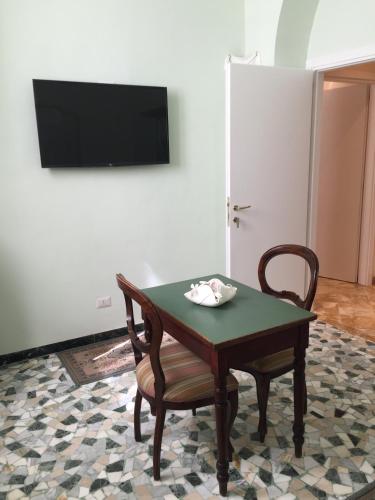 a room with a table and a chair and a television at Casalbergo in Siena