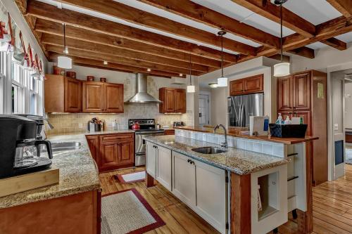 a large kitchen with wooden cabinets and a counter top at 4 bedroom house with hot tub Near Ellicottville in West Valley