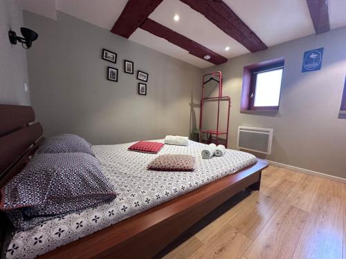 a bedroom with a bed with pillows and a window at B'm Yerri - Centre ville - vue Cathédrale in Colmar