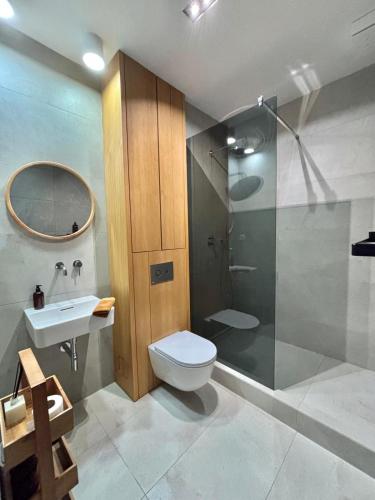 a bathroom with a toilet and a shower and a sink at Apartmán Zara in Komárno