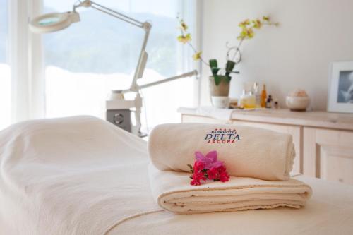 a pile of towels sitting on top of a table at Villa Favorita - Parkhotel Delta in Ascona