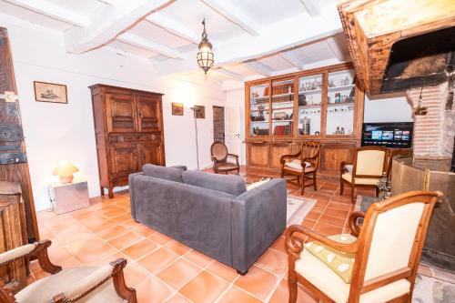 a living room with a couch and chairs at Clos Saint Michel - Piscine - Nature & Calme in Saint-Michel-de-Vax