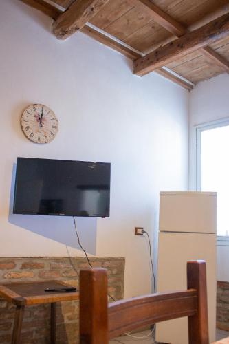 a large flat screen tv hanging on a wall at Agriturismo Valpagliaro in Formignana
