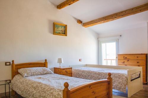 a bedroom with two beds and a window at Agriturismo Valpagliaro in Formignana