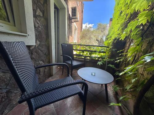 a patio with two chairs and a table on a balcony at Contessa Apartments in Budva