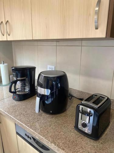 two appliances sitting on a counter in a kitchen at Aruba , Eagle Beach Townhouse in Palm-Eagle Beach