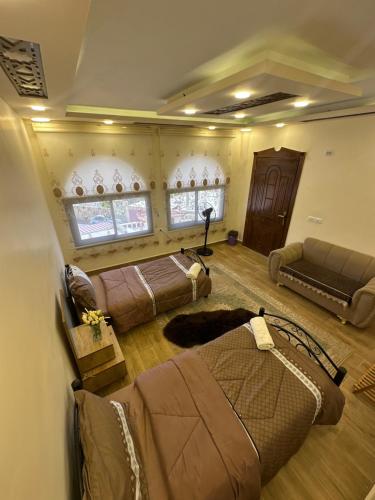 a living room with two beds and a couch at Sewar hostel in Petra